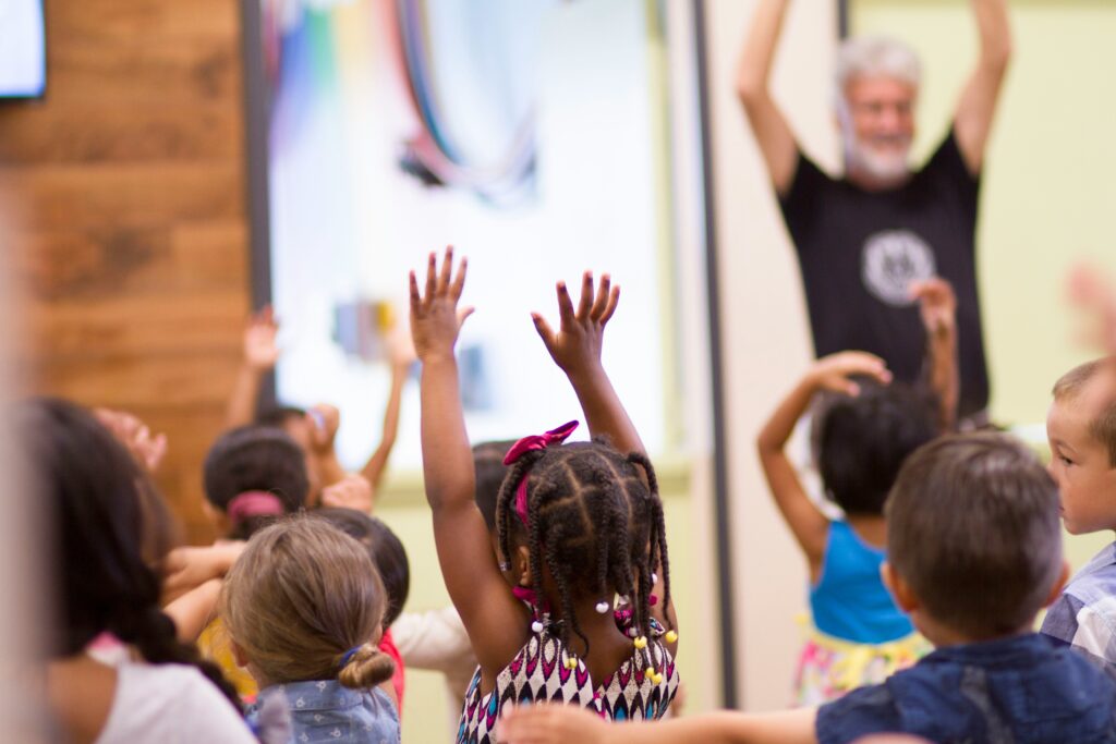 Kids ministry leader engaging children during a high-energy church activity