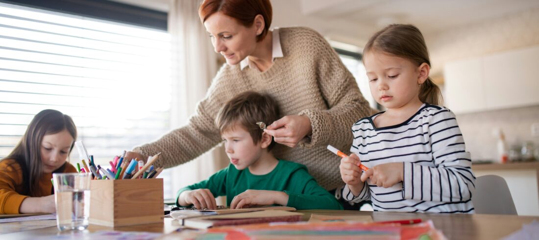 Kids ministry leader supporting volunteers during a classroom activity