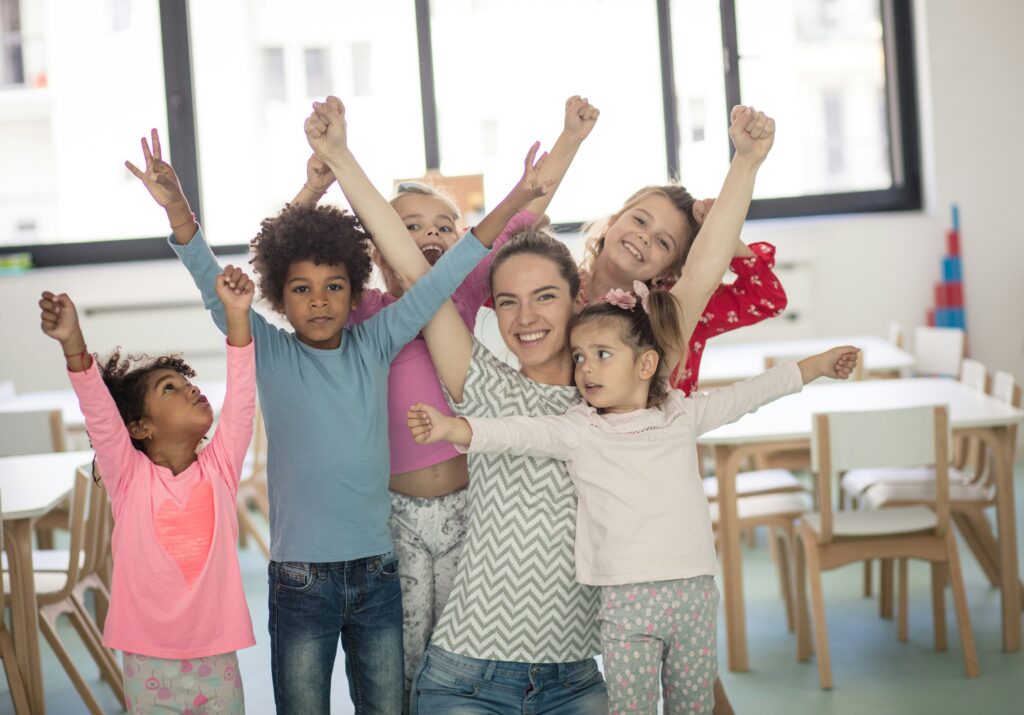 Kids ministry leader celebrating with children, reflecting positive kids ministry leadership and a healthy ministry environment