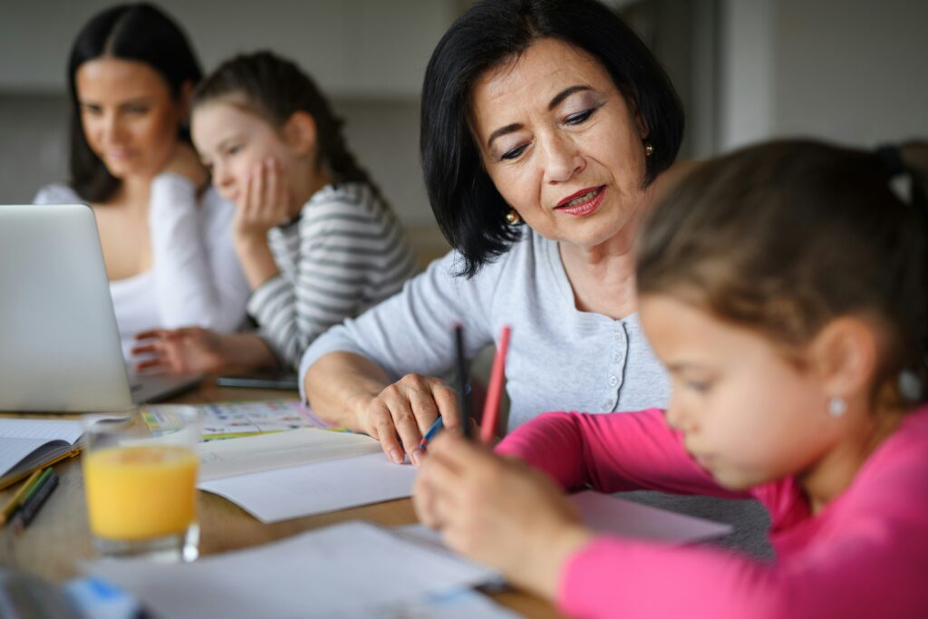 Kids ministry leader supporting a child and family during a learning activity, reflecting the relational weight that can contribute to kids ministry burnout.