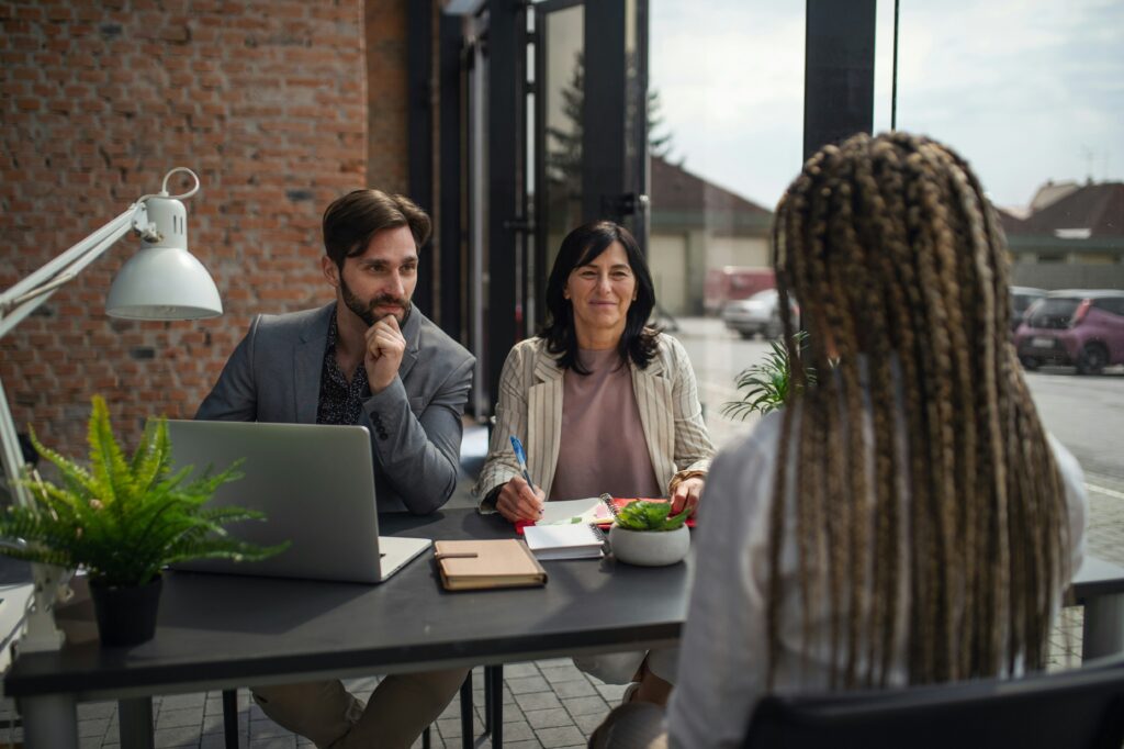 A job candidate engaged in a thoughtful conversation with an interviewer during a professional interview.
